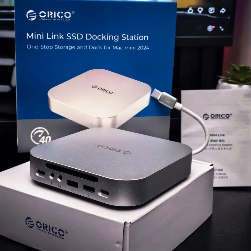ORICO MiniLink Mac Mini M4 Aluminum Docking Station, equipped with an M.2 NVMe SSD slot, supports up to 8TB. Features a 40Gbps USB4 interface, a USB-A (480Mbps) stand with audio I/O, and is compatible